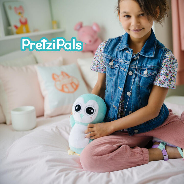 Girl on bed with mint penguin PretziPal